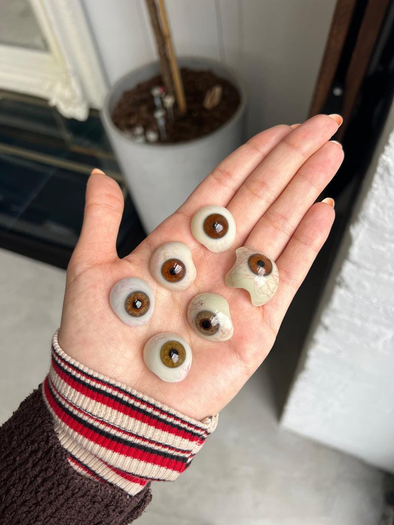 Two vintage glass eyes