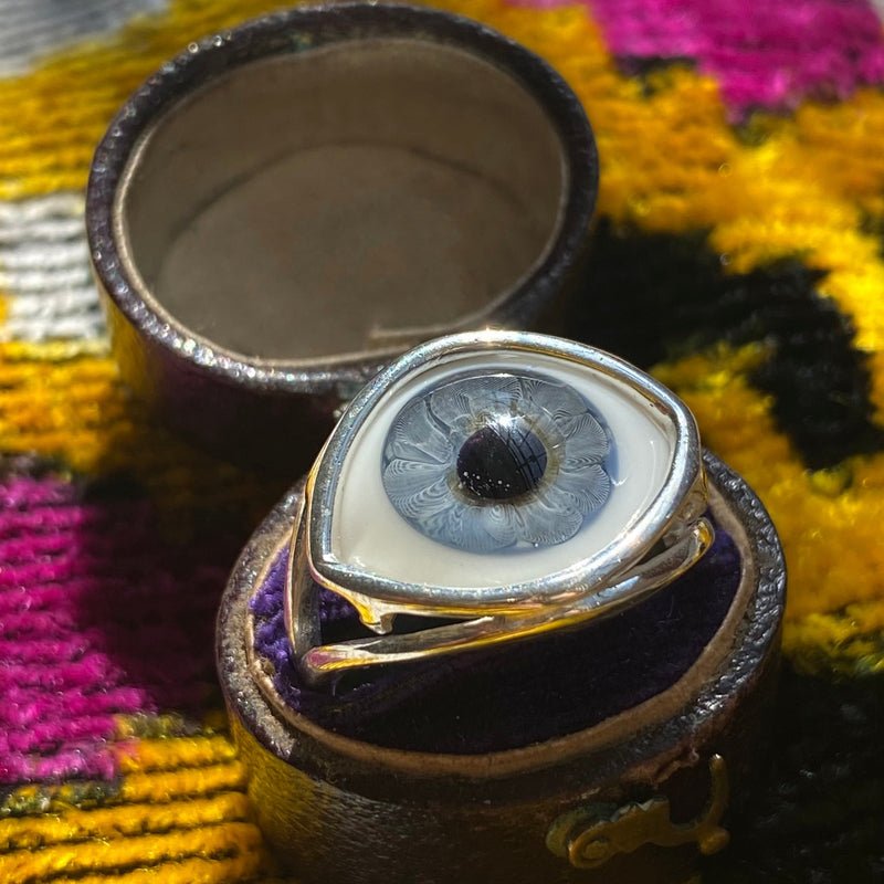 blue glass eye skeleton ring in a jewelry box